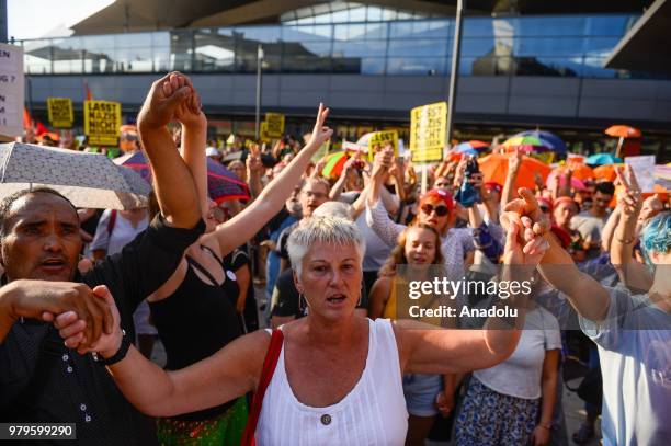 Hundreds of people hold umbrellas as a symbol of protection for refugees during a march against the conservative right wing government Vienna,...