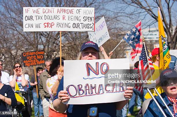 Supporters of the Tea Party movement demonstrate outside the US Capitol in Washington, DC, on March 20, 2010 against the healthcare bill which is...