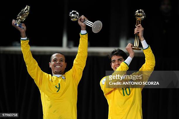 Brazilian midfielder Kaka poses with the "golden ball" he was awarded as best player of the tournament with Brazilian forward Luis Fabiano who was...