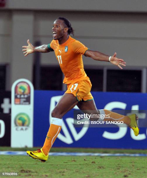 Ivory Coast National football team striker and team captain Didier Drogba c) celebrates a goal against Ghana during their group stage match at the...