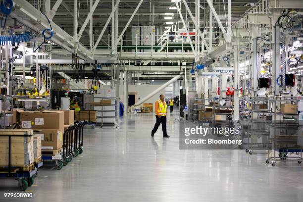 Worker walks through the assembly floor of the Volvo AB S60 sedan manufacturing facility in Ridgeville, South Carolina, U.S., on Wednesday, June 20,...