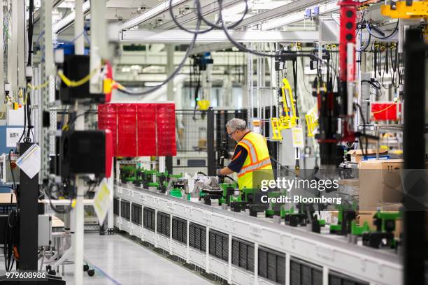 Worker assembles parts for wheels during production of a Volvo AB S60 sedan at the Volvo Cars USA plant in Ridgeville, South Carolina, U.S., on...