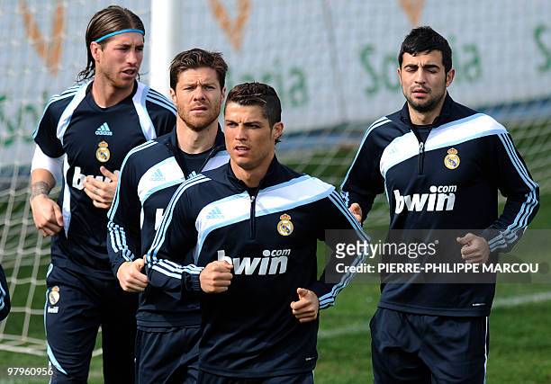 Real Madrid football club's defender Sergio Ramos , midfielder Xabi Alonso , Portuguese forward Cristiano Ronaldo and defender Alvaro Arbeloa train...