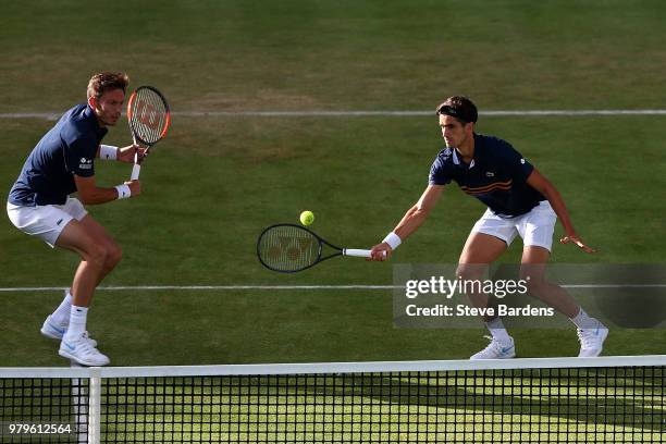 Pierre-Hughes Herbert and Nicolas Mahut of France in action during their doubles match against Nick Kyrgios and Lleyton Hewitt of Australia on Day...