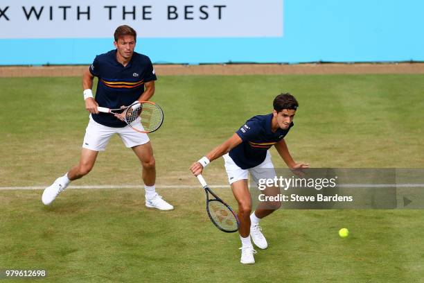 Pierre-Hughes Herbert and Nicolas Mahut of France in action during their doubles match against Nick Kyrgios and Lleyton Hewitt of Australia on Day...