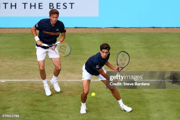 Pierre-Hughes Herbert and Nicolas Mahut of France in action during their doubles match against Nick Kyrgios and Lleyton Hewitt of Australia on Day...