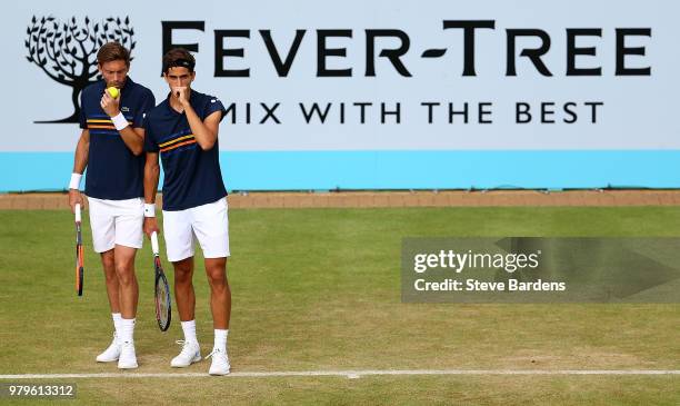 Pierre-Hughes Herbert and Nicolas Mahut of France in action during their doubles match against Nick Kyrgios and Lleyton Hewitt of Australia on Day...