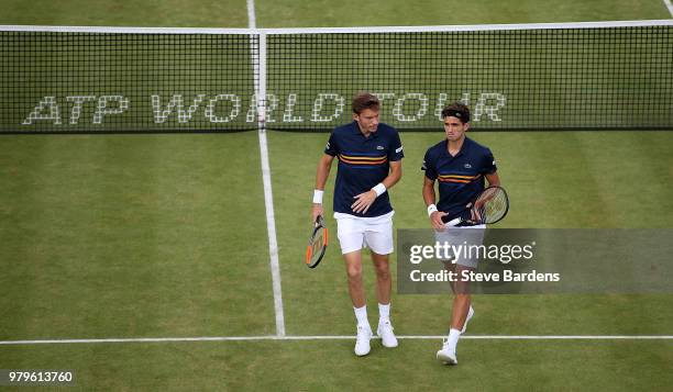 Pierre-Hughes Herbert and Nicolas Mahut of France in action during their doubles match against Nick Kyrgios and Lleyton Hewitt of Australia on Day...