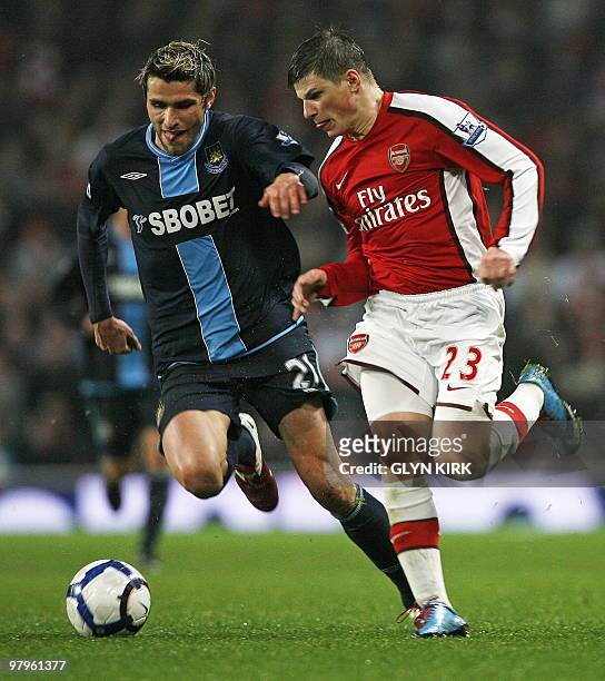 Arsenal's Russian player Andrey Arshavin vies with West Ham's Swiss player Valon Behrami during the English Premier League football match between...