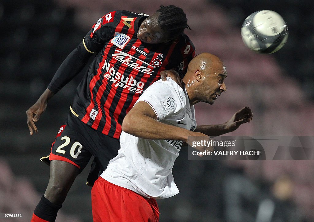 PSG defender Sammy Traore (R) vies with