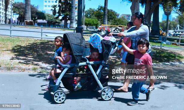 Babysitter Eusebia, from Guatemala, walks with children through MacArthur Park in the predominantly Hispanic/Latino neighborhood of Westlake in Los...