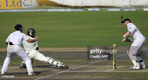 Bangladeshi cricketer Jahurul Islam looks back towards his shattered wicket as England wicketkeeper Matt Prior and teammate Ian Bell celebrate his...