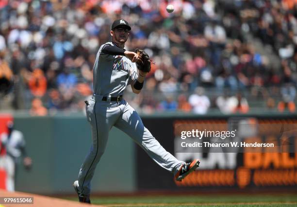 Riddle of the Miami Marlins throws off balance to first base throwing out Mac Williamson of the San Francisco Giants in the bottom of the fourth...