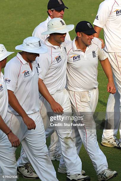 England bowler James Tredwell gets a hug from Jonathan Trott after Trott had dropped a simple catch off Tredwell earlier in the day during day four...