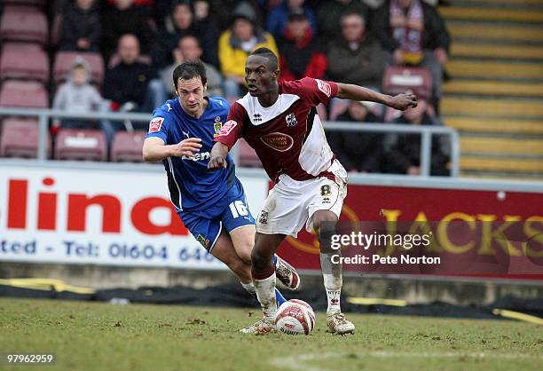 Abdul Osman of Northampton Town looks to move away from Stewart Drummond of Morecambe during the Coca Cola League Two Match between Northampton Town...