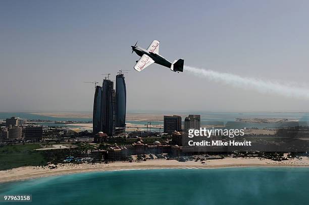 Hannes Arch of Austria soars above the Emirates Palace hotel and the Etihad Towers during the Abu Dhabi Red Bull Air Race fly in and Calibration day...