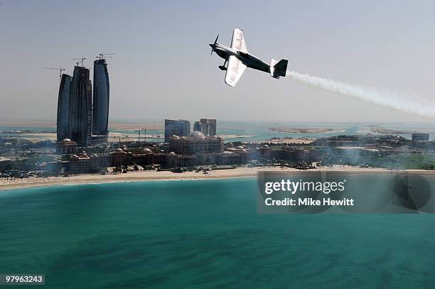 Hannes Arch of Austria soars above the Emirates Palace hotel and the Etihad Towers during the Abu Dhabi Red Bull Air Race fly in and Calibration day...