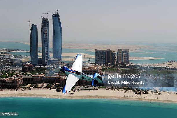Martin Sonka of Czech Republic soars above the Emirates Palace hotel and the Etihad Towers during the Abu Dhabi Red Bull Air Race fly in and...