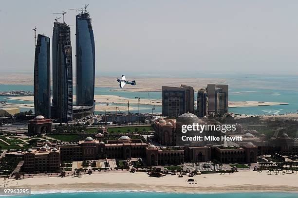 Martin Sonka of Czech Republic soars above the Emirates Palace hotel and the Etihad Towers during the Abu Dhabi Red Bull Air Race fly in and...