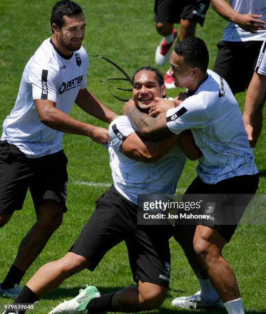 New Zealand Kiwis rugby team players tackle teammate Martin Taupau at University of Denver on June 20, 2018 in Denver, Colorado.