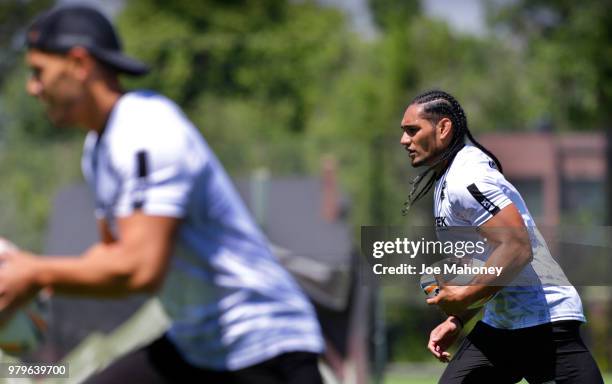 Martin Taupau of the New Zealand Kiwis rugby team, left, carries the ball during a training session at University of Denver on June 20, 2018 in...
