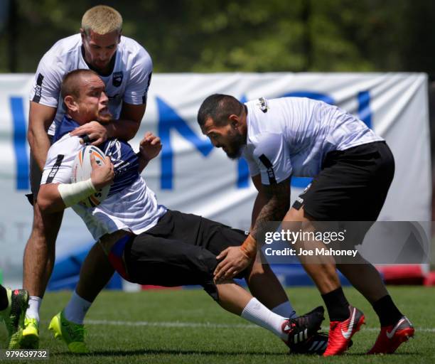 Nelson Asofa-Solomona, left, Leeson Ah Mau of the New Zealand Kiwis rugby team tackle teammate Jared Waerea-Hargreaves during a training session at...