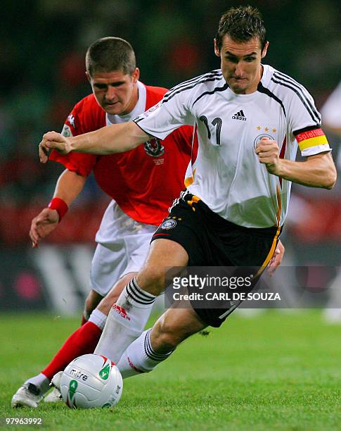 Germany's match goal scorer, Miroslav Klose vies with Welsh Carl Robinson during their Euro 2008 Group D qualifying match Wales vs Germany at the...