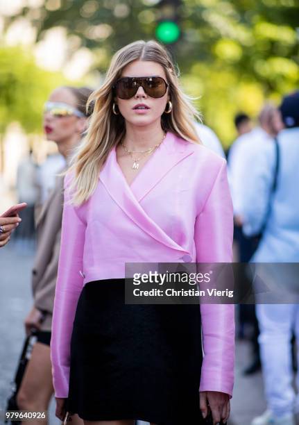 Model Maryna Linchuk wearing pink blouse, black mini skirt is seen outside Off/White on day two of Paris Fashion Week Menswear SS19 on June 20, 2018...