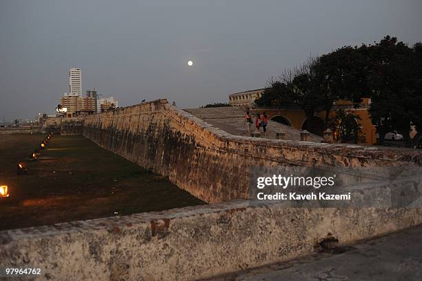 Of INDIAS, COLOMBIA Full moon falls over the old city walls in Cartagena. This particular site is where lovers come to sit around and chat and...