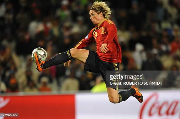 Spanish forward Fernando Torres jumps for a ball during the Fifa Confederations Cup semi-final football match Spain against the United States on June...