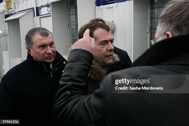 Russian President Dmitry Medvedev and First Deputy Prime Minister Igor Sechin listen to CEO of Surgutneftegaz Vladimir Bogdanov during a visit to the...