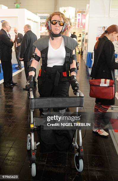 Year-old Anna Blinow walks with a seniority simulating equipment called "MAX" on March 23, 2010 in Hanover, northern Germany, during the fair...