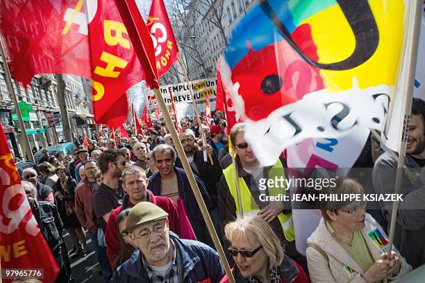 People demonstrate on March 23, 2010 in Lyon, as part of a nationwide day of protest against job cuts, wages, the high cost of living and plans for...