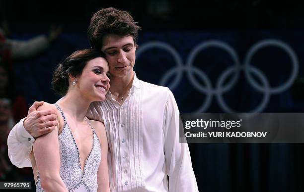 Gold medallists, Canada's Tessa Virtue and Scott Moir, react on the podium during the medal ceremony after performing in the Ice Dance Free program...