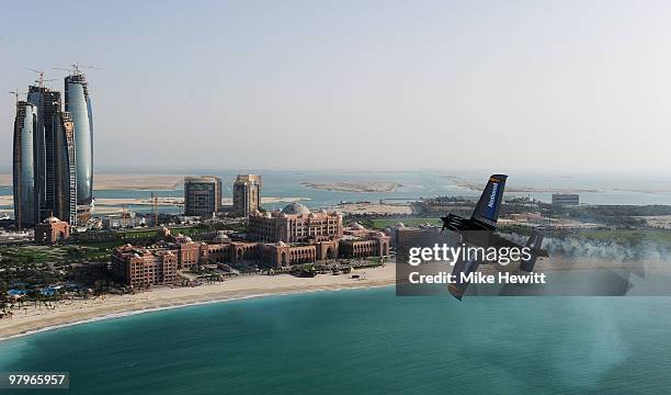 Alejandro Maclean of Spain soars above the Emirates Palace hotel and the Etihad Towers during the Abu Dhabi Red Bull Air Race fly in and Calibration...