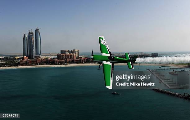 Michael Goulian of USA soars above the Emirates Palace hotel and the Etihad Towers during the Abu Dhabi Red Bull Air Race fly in and Calibration day...
