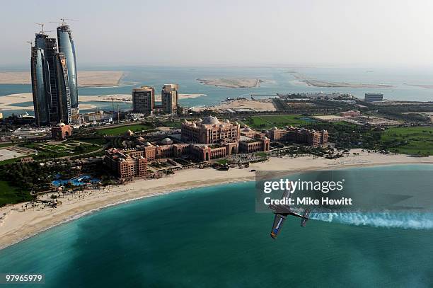 Alejandro Maclean of Spain soars above the Emirates Palace hotel and the Etihad Towers during the Abu Dhabi Red Bull Air Race fly in and Calibration...