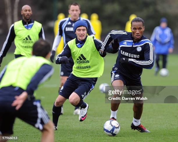 Yury Zhirkov and Didier Drogba of Chelsea during a training session at the Cobham training ground on March 23, 2010 in Cobham, England.