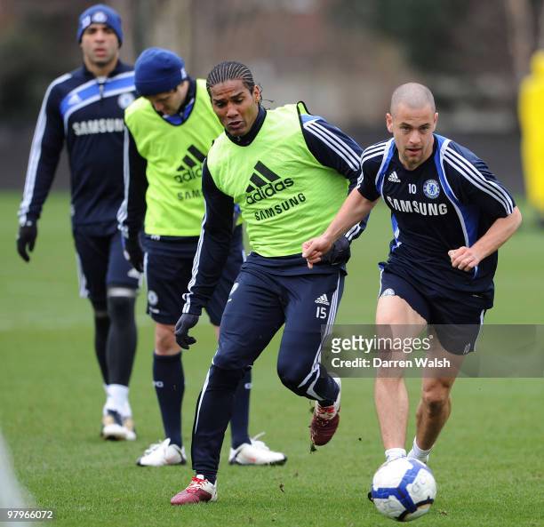 Joe Cole and Florent Malouda of Chelsea during a training session at the Cobham training ground on March 23, 2010 in Cobham, England.