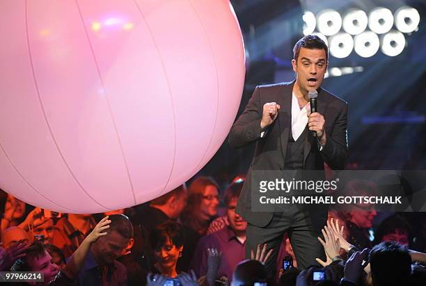 British singer Robbie Williams performs on stage after receiving his Echo in the category "Best International Rock/Pop" at the "Echo" music awards in...