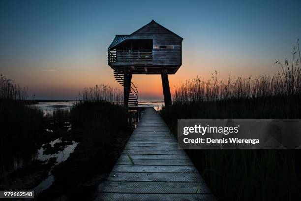 wooden watchtower in beach at dusk, groningen, netherlands - uitkijktoren stockfoto's en -beelden