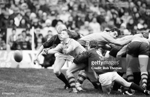 Nick Farr-Jones passes the ball as he is tackled by Roy Laidlaw of Scotland during the Scotland v Australia International Rugby Union match played at...