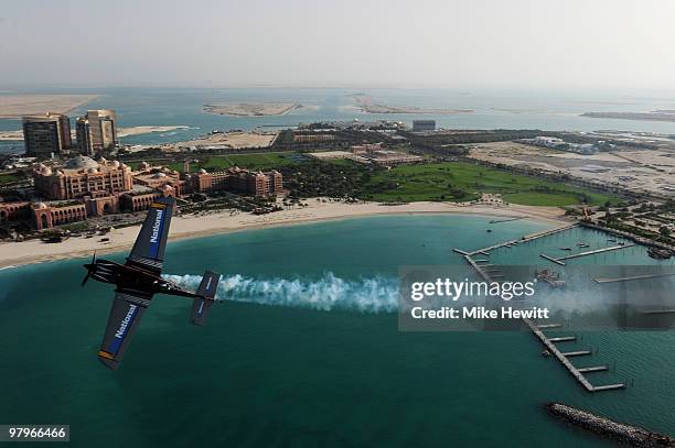 Alejandro Maclean of Spain soars above the Emirates Palace hotel and the Etihad Towers during the Abu Dhabi Red Bull Air Race fly in and Calibration...