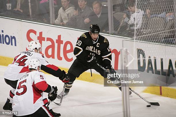 Brenden Morrow of the Dallas Stars looks to pass to a teammate against Chris Campoli and Andy Sutton of the Ottawa Senators on March 20, 2010 at the...