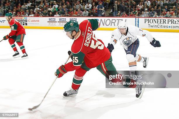 Nick Schultz of the Minnesota Wild takes a shot with Robert Nilsson of the Edmonton Oilers defending during the game at the Xcel Energy Center on...