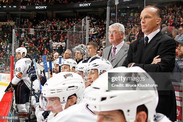 Edmonton Oilers Head Coach Pat Quinn and Assistant Coach Kelly Buchberger watch from behind the bench during the game against the Minnesota Wild at...