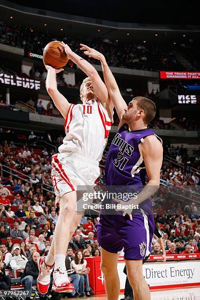 Chase Budinger of the Houston Rockets shoots against Spencer Hawes of the Sacramento Kings during the game on March 3, 2010 at the Toyota Center in...