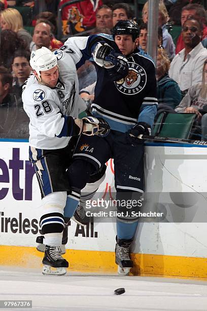 Byron Bitz of the Florida Panthers collides with Zenon Konopka of the Tampa Bay Lightning at the BankAtlantic Center on March 21, 2010 in Sunrise,...