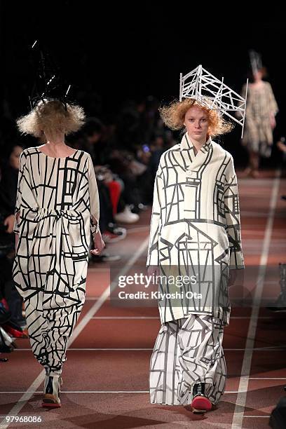 Models showcase the mintdesigns 2010-2011 Autumn/Winter Collection designed by Hokuto Katsui and Nao Yagi on the catwalk at the National Stadium on...