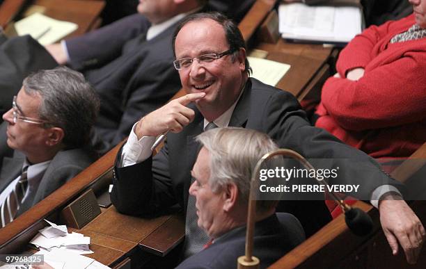 France's socialists deputies Francois Hollande and Jean-Marc Ayrault attend a session of questions to the government on March 23, 2010 at the French...